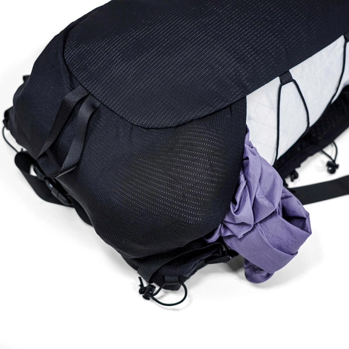 Bonfus Fastus 23L bottom pocket detail - zippered base pocket for small essentials on ultralight DCF pack