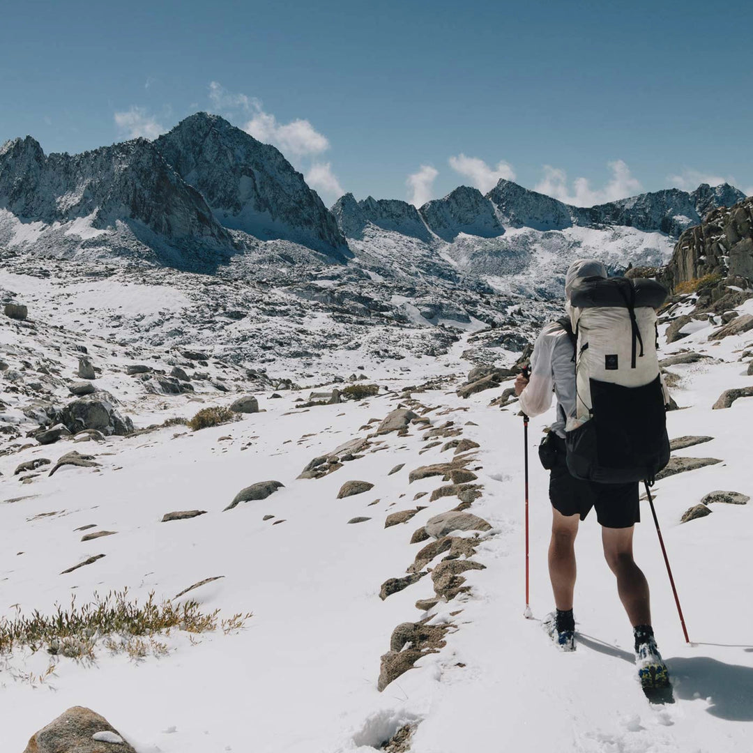 Bonfus Framus 58L ultralight pack trail photo - DCF Dyneema backpack in rugged mountain terrain