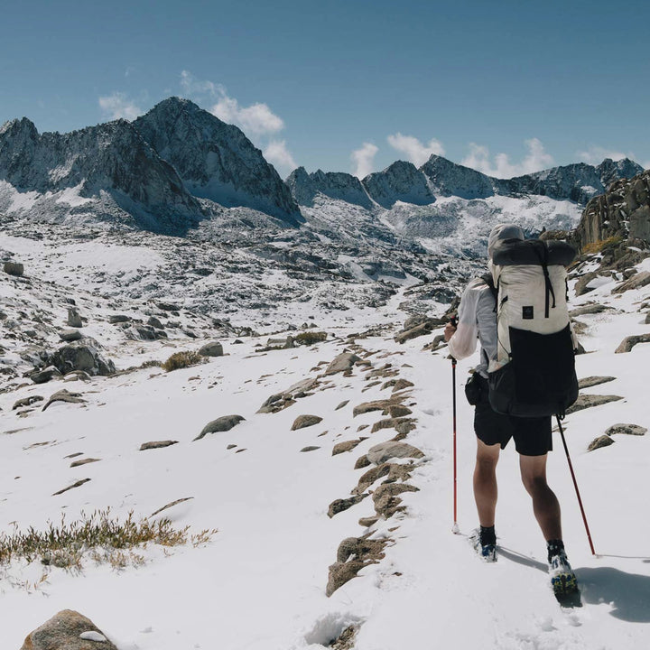 Bonfus Framus 58L ultralight pack trail photo - DCF Dyneema backpack in rugged mountain terrain
