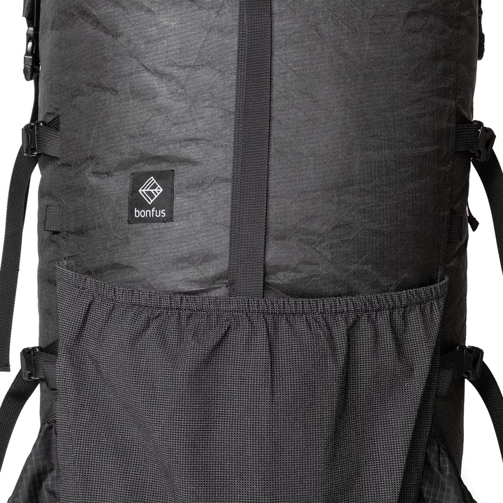 Bonfus Maxus 80L front pocket detail - stretchy mesh front pocket for quick-access gear on ultralight DCF pack