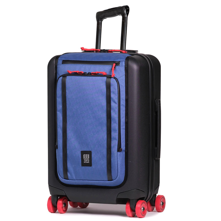 Topo Designs Global Pro Travel Roller in Ocean Blue with black shell and red spinner wheels