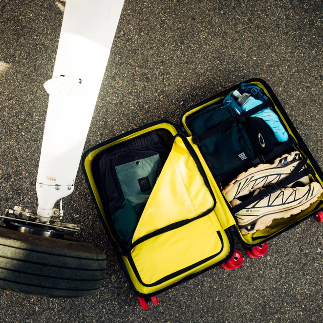 Topo Designs Global Pro Travel Roller open and packed with clothing and travel gear