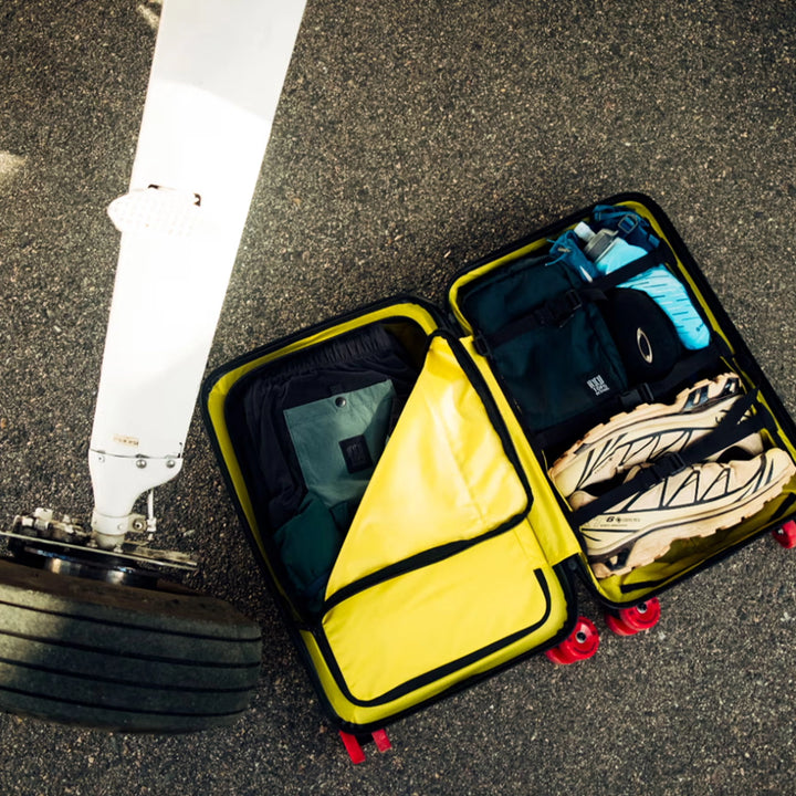 Topo Designs Global Pro Travel Roller open and packed with clothing and travel gear