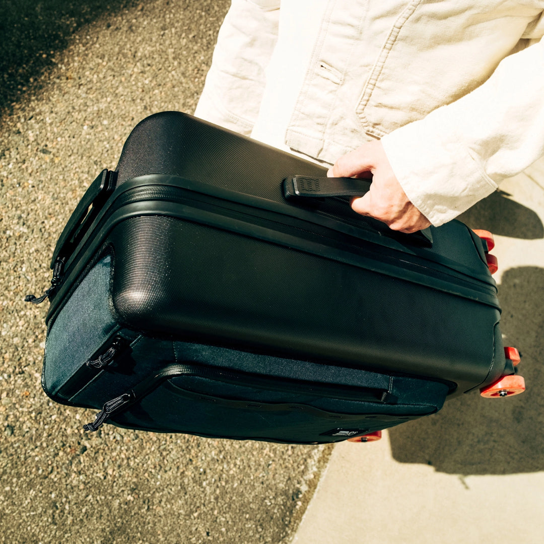 Topo Designs Global Pro Travel Roller showing integrated side carry handle