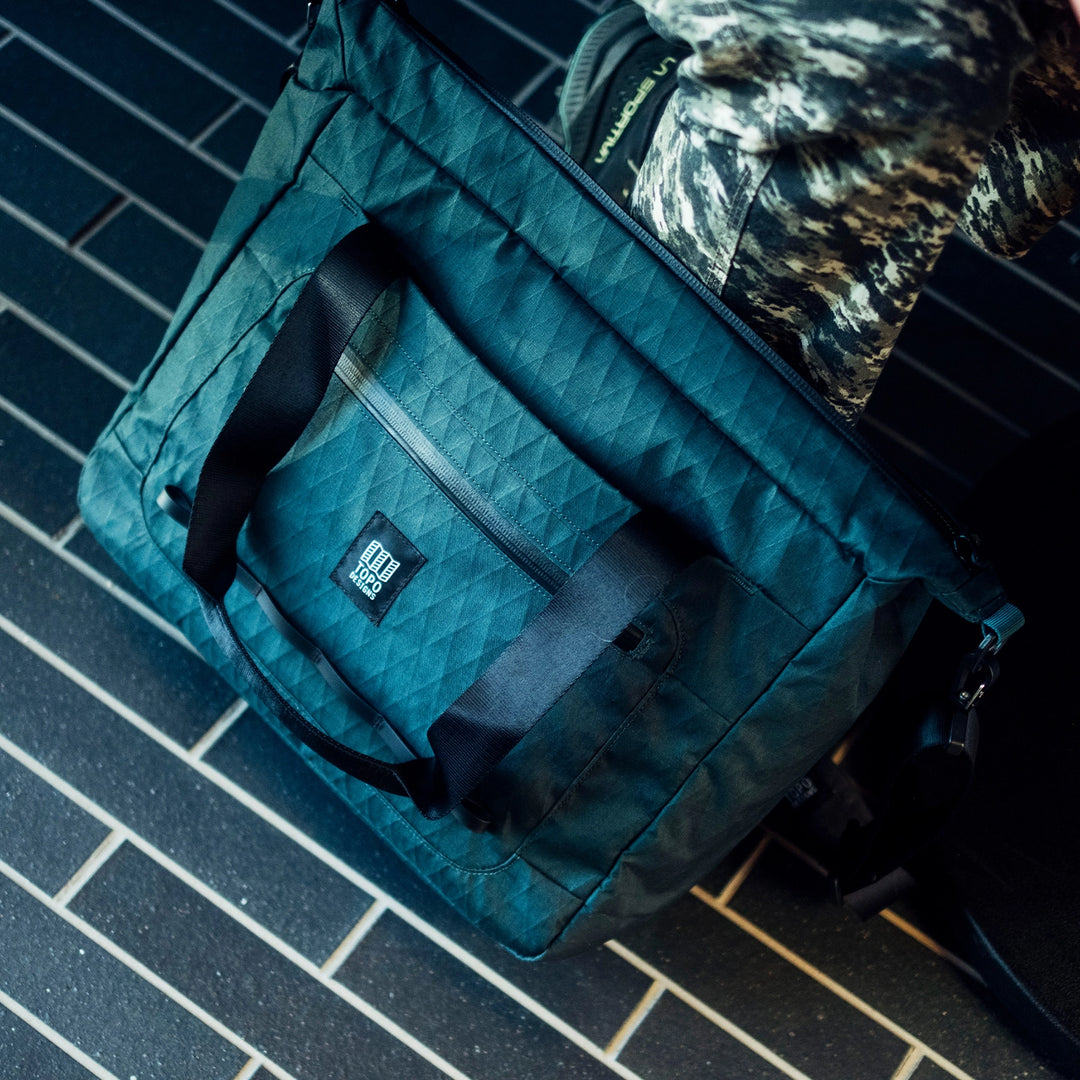 Topo Designs Global Pro Travel Tote - zippered pocket detail of tote bag with a mutli-carry solution for the office commute or the long weekend